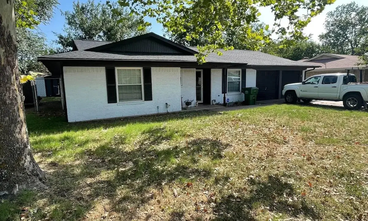 Professional roofing crew working on a residential roof in Americus